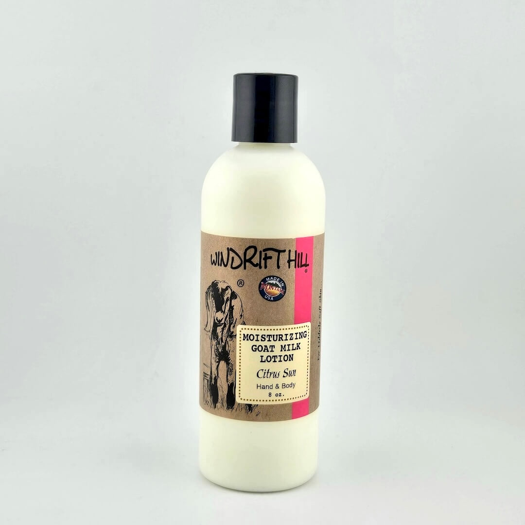 Plastic bottle of Windrift Hill moisturizing goat milk lotion on a gray background