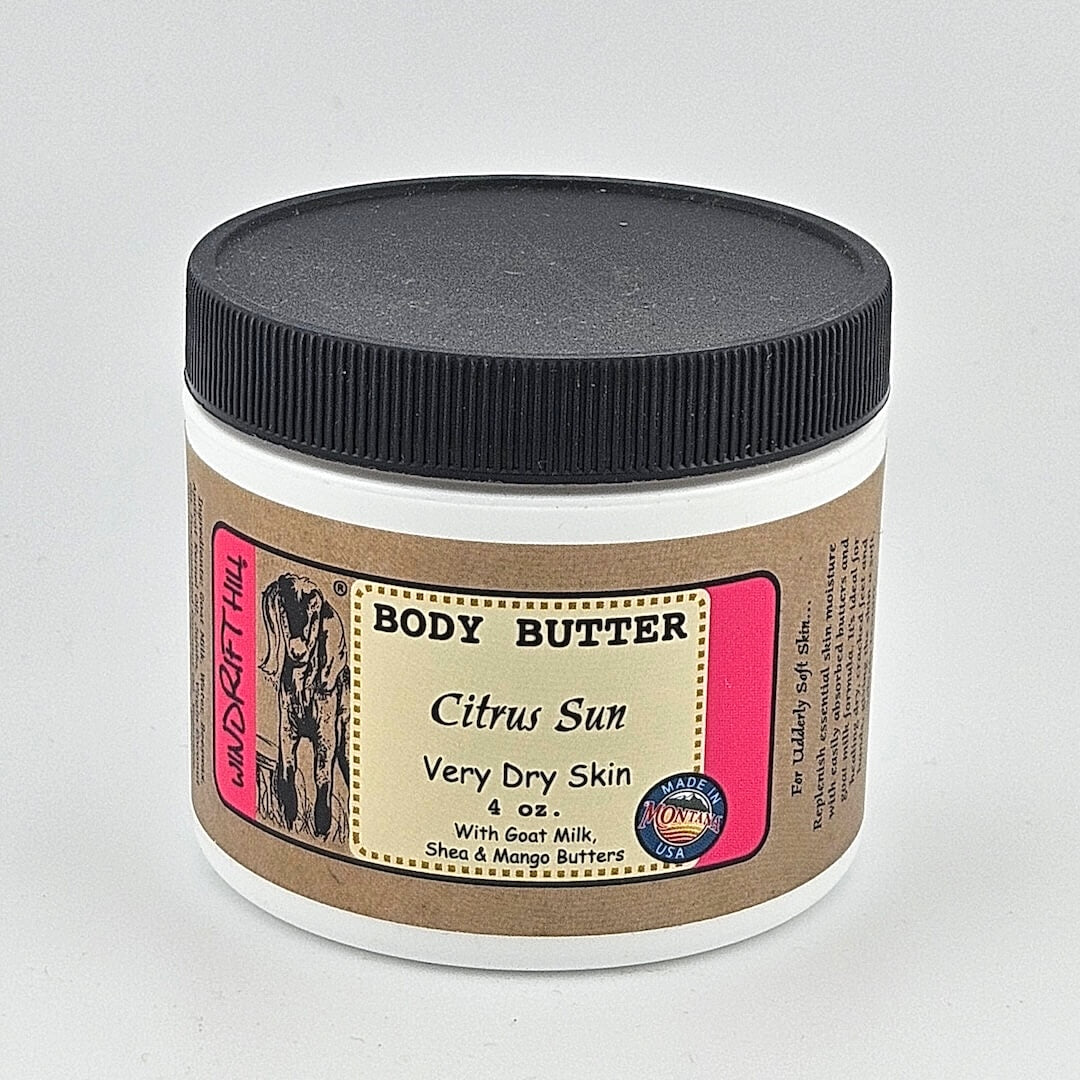 Jar of body butter labeled 'Citrus Sun' on a gray background