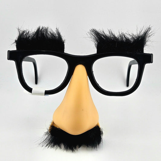 Glasses with black frames and black hair extensions, paired with a beige nose and black hair extensions on a light gray background.