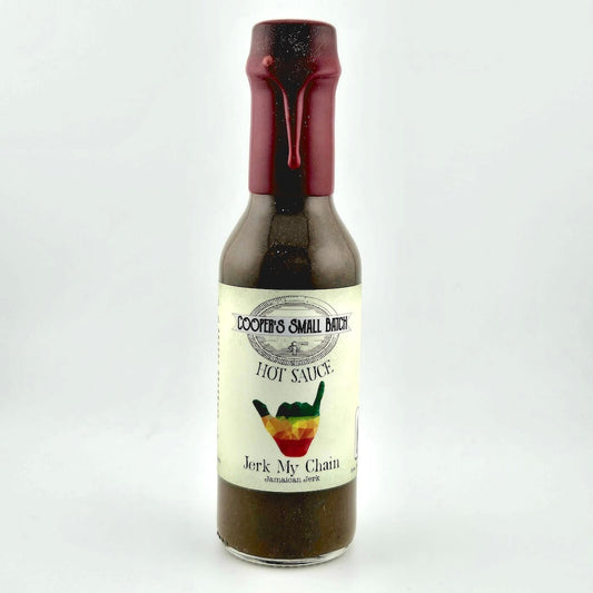 Bottle of 'Jerk My Chain' hot sauce with a red cap on a white background