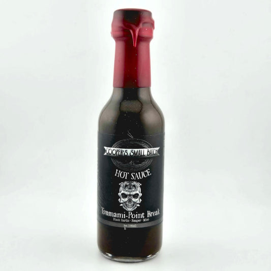 Bottle of hot sauce with a red cap on a white background