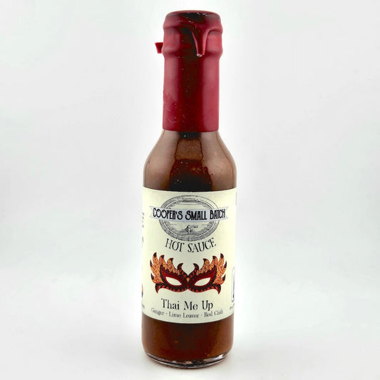 Bottle of Coover's Small Batch Hot Sauce with a red cap on a white background