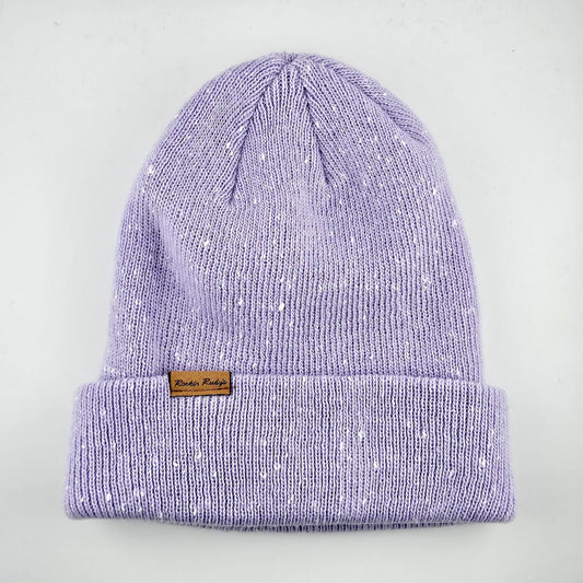 Purple knit beanie with a brand label on a light gray background