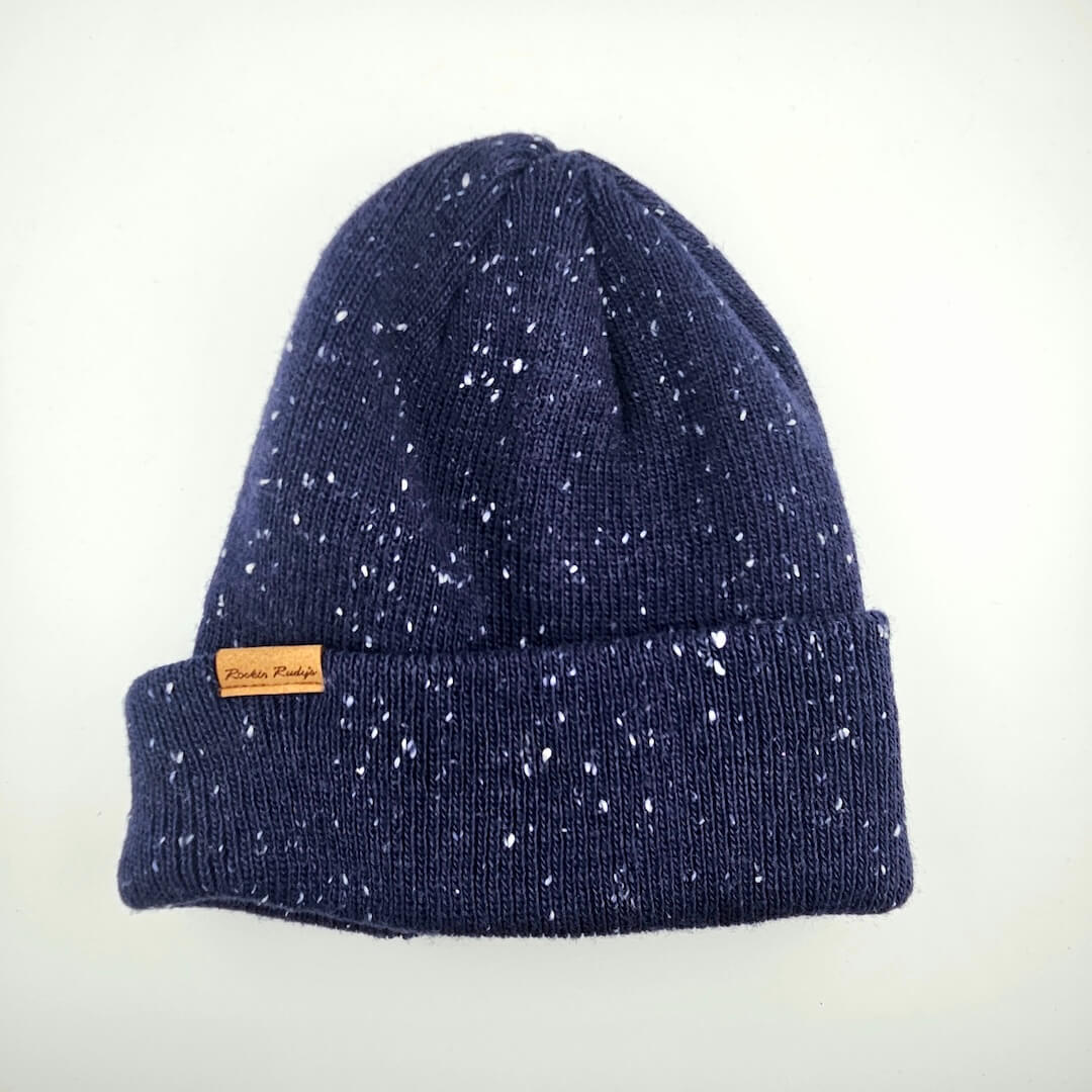 Navy blue speckled beanie with a brand label on a white background