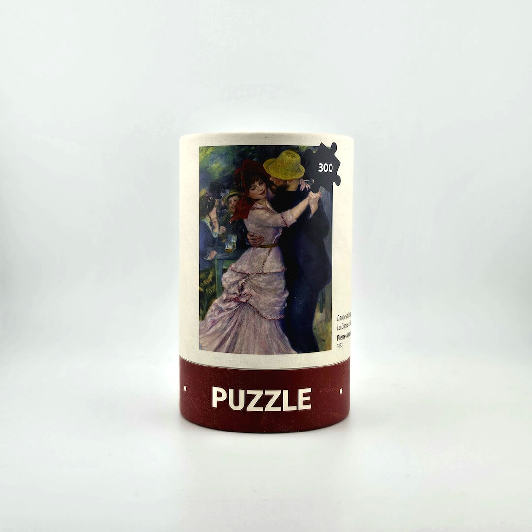 Jigsaw puzzle box with artwork of a couple dancing on a white background