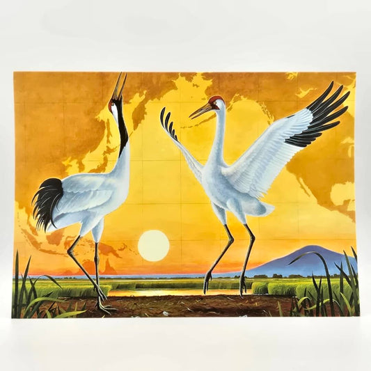 Illustration of two cranes dancing in a field with a sunset in the background