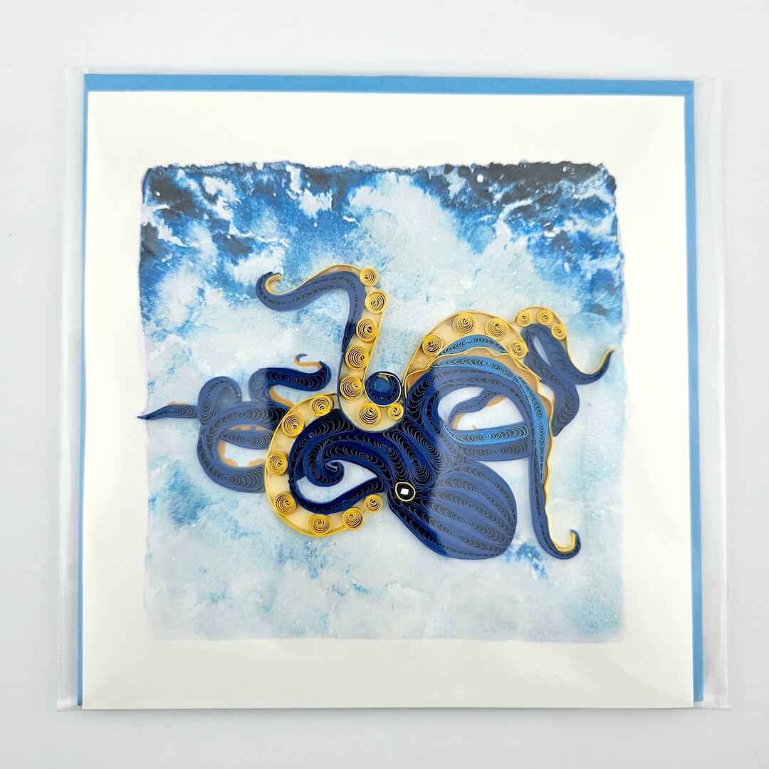Card with a blue and gold octopus design on a watercolor background
