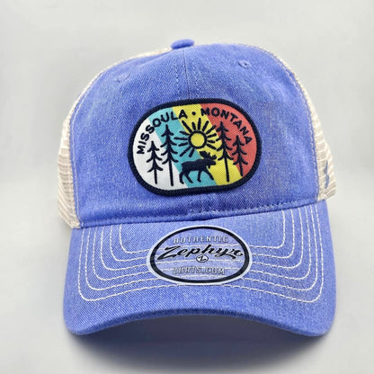 Blue ball cap with white mesh back & stitching, multicolored patch on face with tree line drawing & city name.