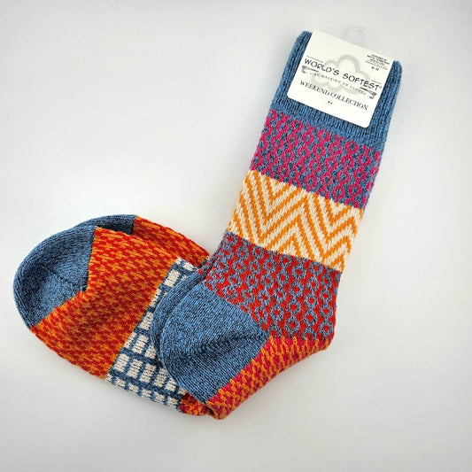 Colorful patterned socks with a visible brand label on a light gray background