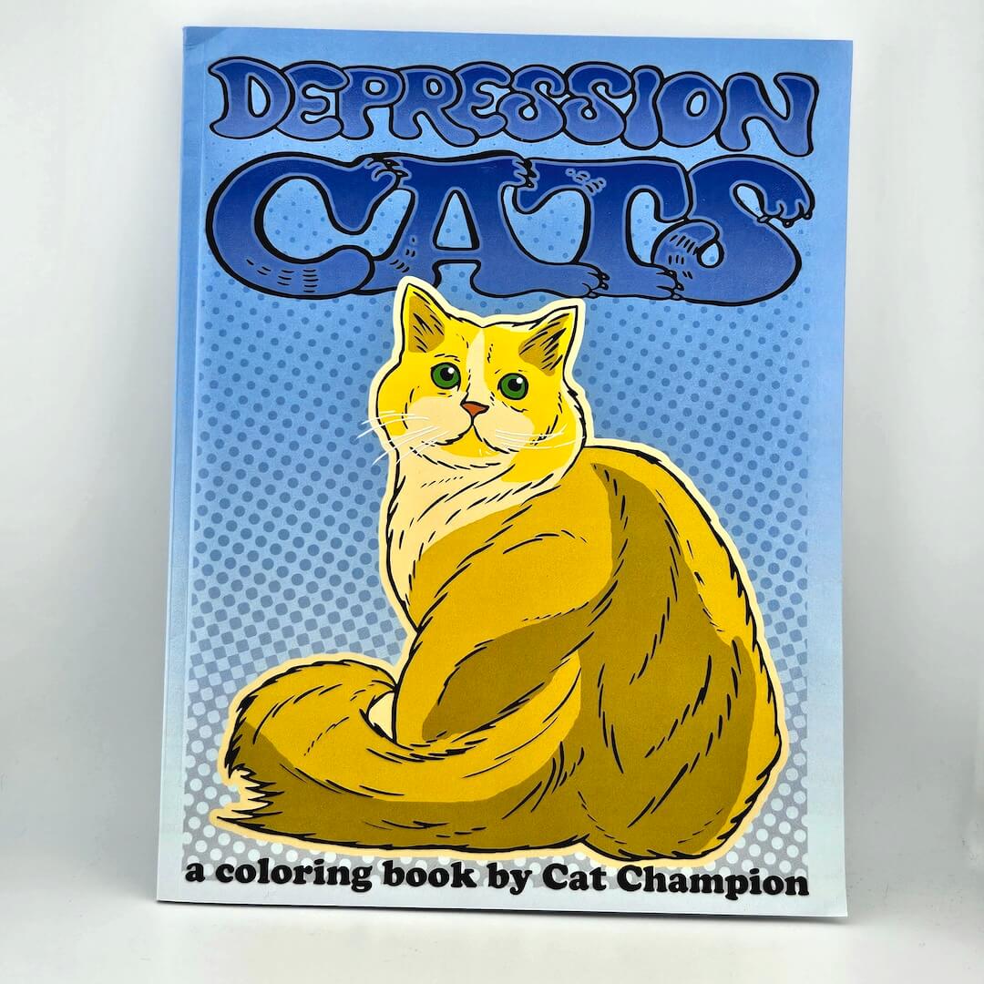 Book titled 'Depression Cats' with a cat illustration on a blue and white background