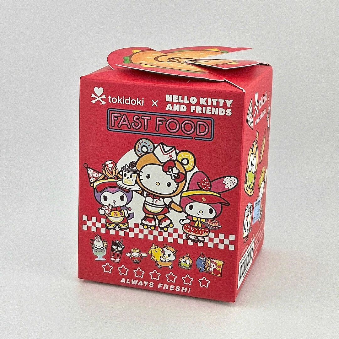 Brightly colored packaging for blind box with Hello Kitty branding against gray background. 