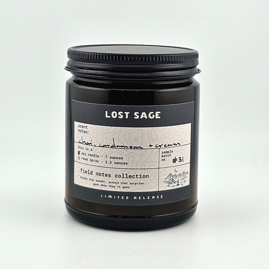 Black candle jar with 'Lost Sage' label on a white background
