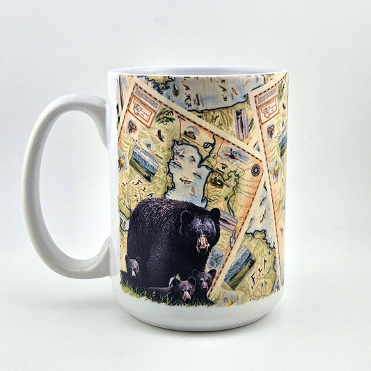 White mug with map and animal design against white background.