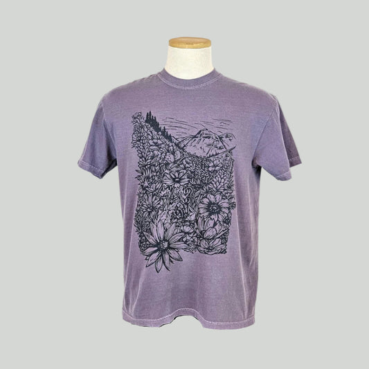 Purple t-shirt with floral and mountain design on a mannequin against a white background