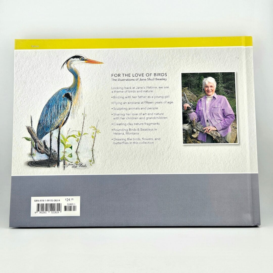 Bookback with illustration of a blue heron, text, and a photo of a person holding a bird.