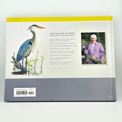 Bookback with illustration of a blue heron, text, and a photo of a person holding a bird.