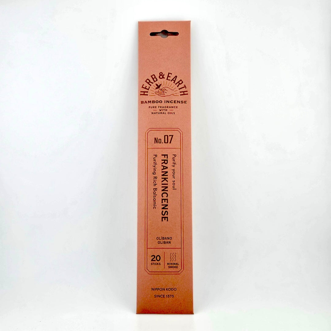 salmon pink rectangular package of incense with brown text describing product. 