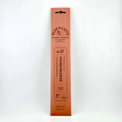 salmon pink rectangular package of incense with brown text describing product. 