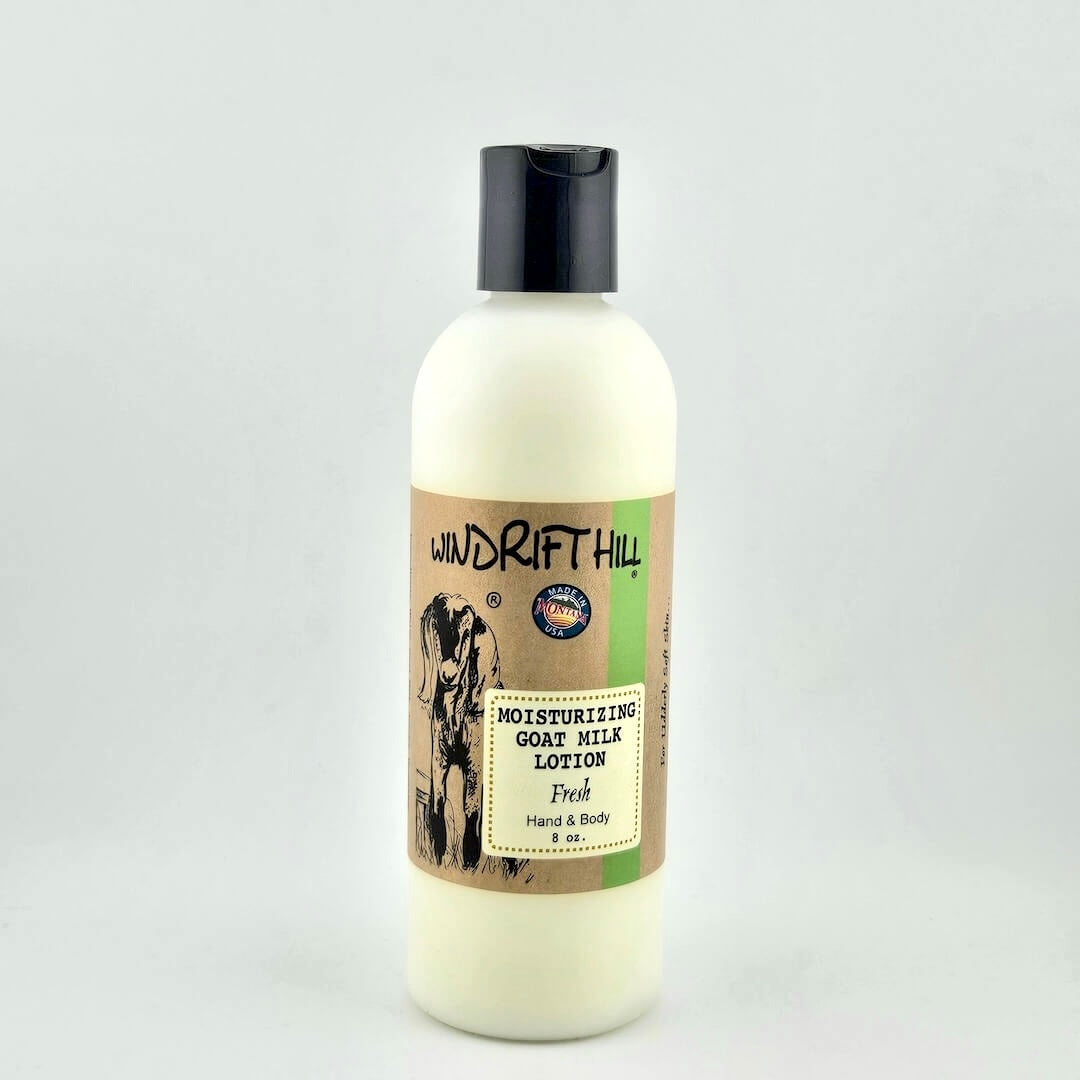 Plastic bottle of Windrift Hill moisturizing goat milk lotion on a gray background