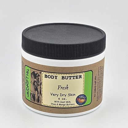 Body butter jar with a black lid on a gray background
