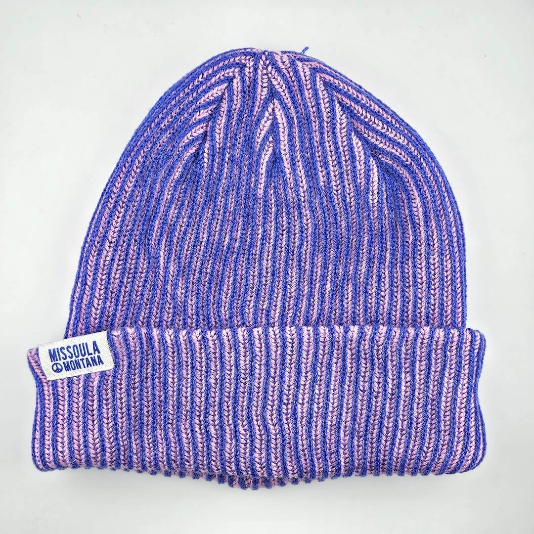 Purple and pink striped beanie with 'Missoula Montana' label on a white background