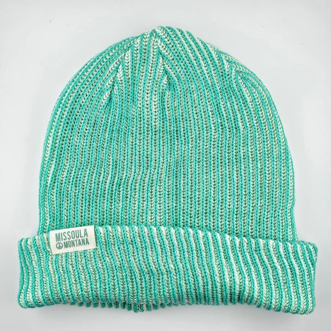 Teal knit beanie with 'Missoula Montana' label on a light gray background