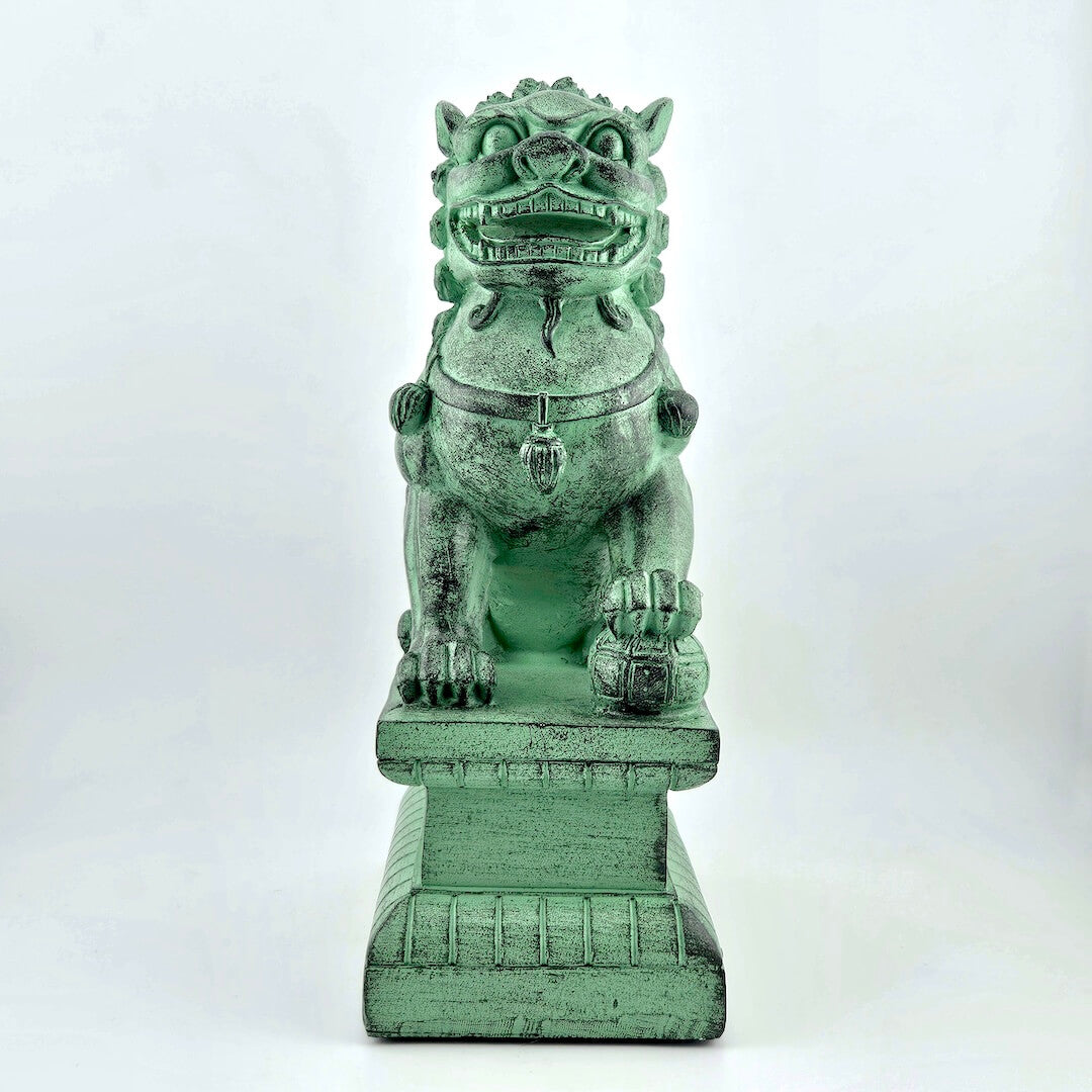 Green stone lion dog statue on a white background
