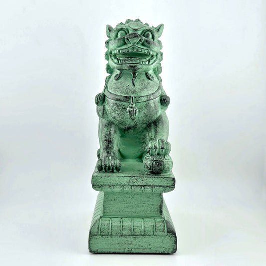 Green stone lion dog statue on a white background
