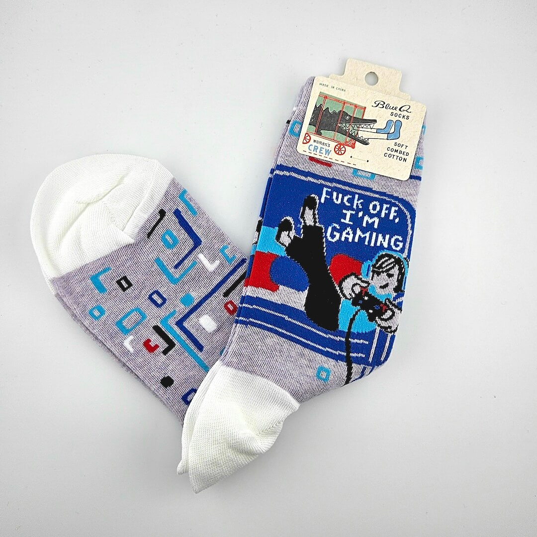 Two pairs of socks with graphic designs on a gray background