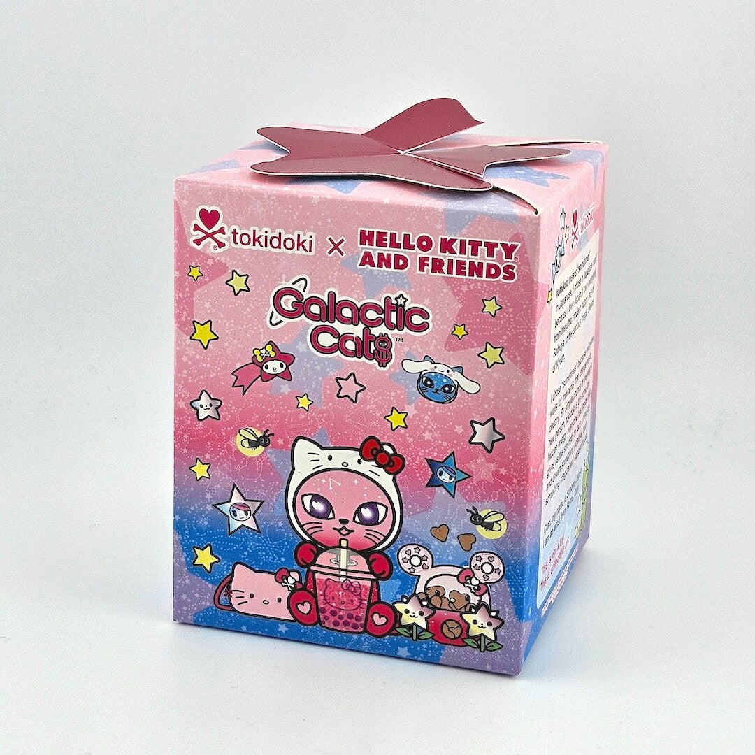 Brightly colored packaging for blind box with Hello Kitty branding against gray background. 