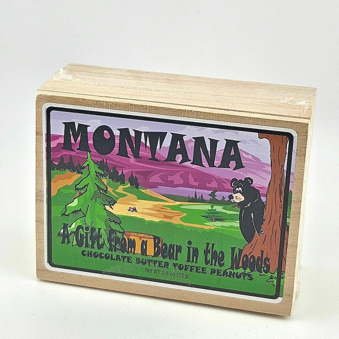 Wooden box with a colorful label featuring a bear and mountains, labeled 'Montana: A Gift from a Bear in the Woods'.