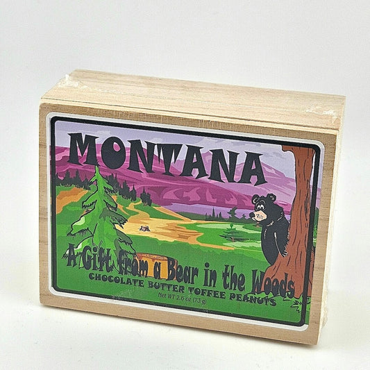 Wooden box with a colorful label featuring a bear and mountains, labeled 'Montana: A Gift from a Bear in the Woods'.