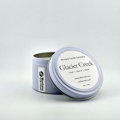 Lavender tin candle with lid, label with printed scent name at top then listed scent components then more details below.