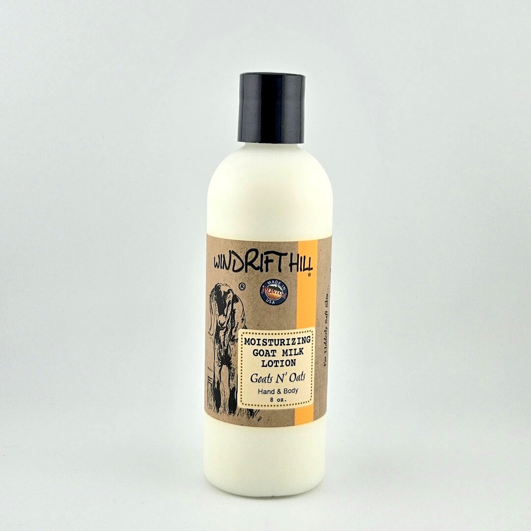 Plastic bottle of Windrift Hill moisturizing goat milk lotion on a gray background