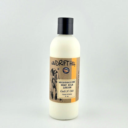 Plastic bottle of Windrift Hill moisturizing goat milk lotion on a gray background