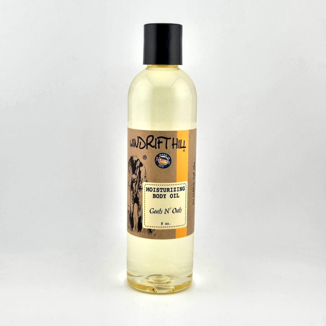 Plastic bottle of Windrift Hill moisturizing body oil on a gray background