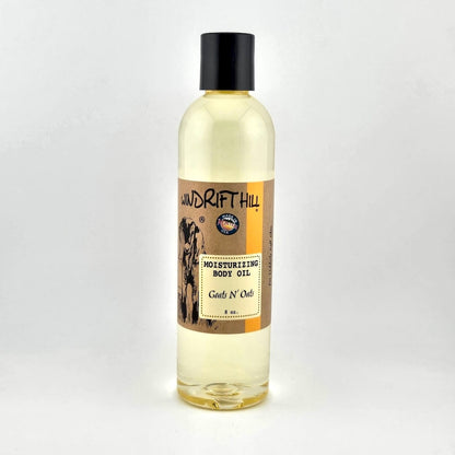 Plastic bottle of Windrift Hill moisturizing body oil on a gray background