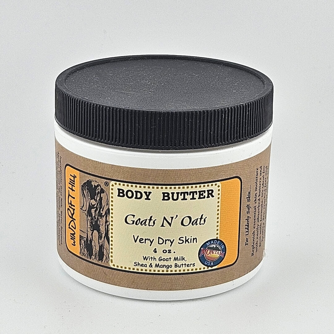 Jar of body butter labeled 'Goats N' Oats' on a gray background