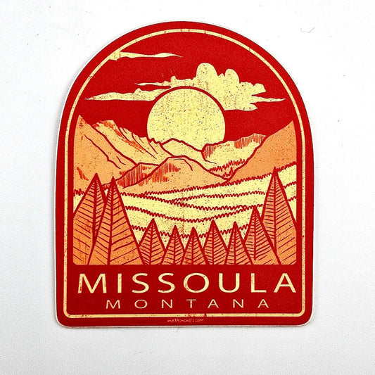 Sticker with mountain and sun design featuring 'Missoula, Montana' text on a white background
