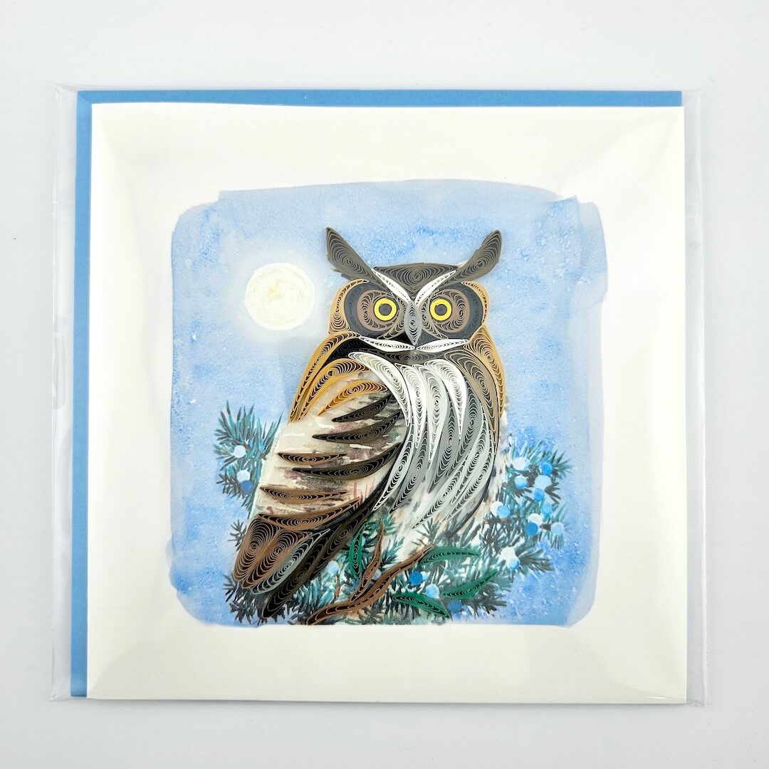 Greeting card with an owl illustration on a blue background
