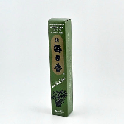 Green box of 50 incense sticks with Japanese writing above bonsai tree.
