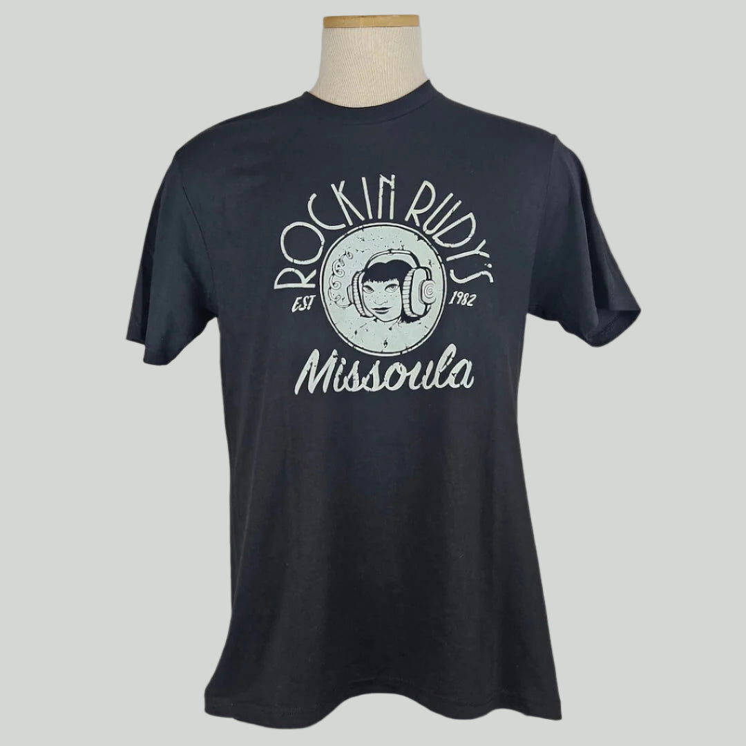 Black short sleeve t-shirt with center image is girl wearing headphones with "ROCKIN RUDY'S" above & "MISSOULA" below. 