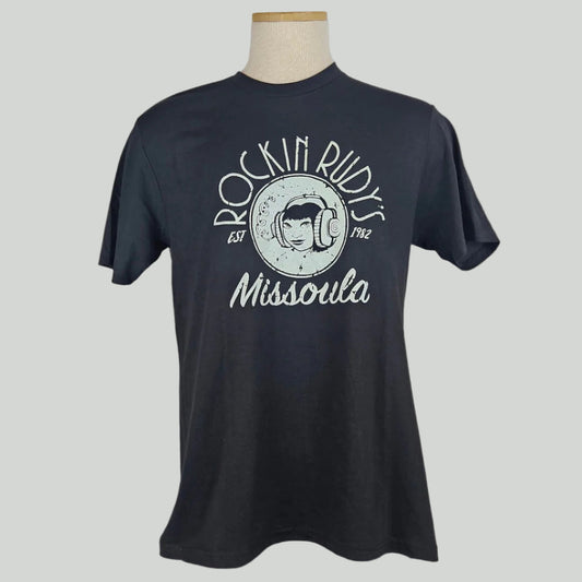 Black short sleeve t-shirt with center image is girl wearing headphones with "ROCKIN RUDY'S" above & "MISSOULA" below. 