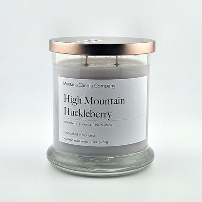 Glass jarred candle with copper lid, label with printed company name top, scent name in center, then listed scent components.