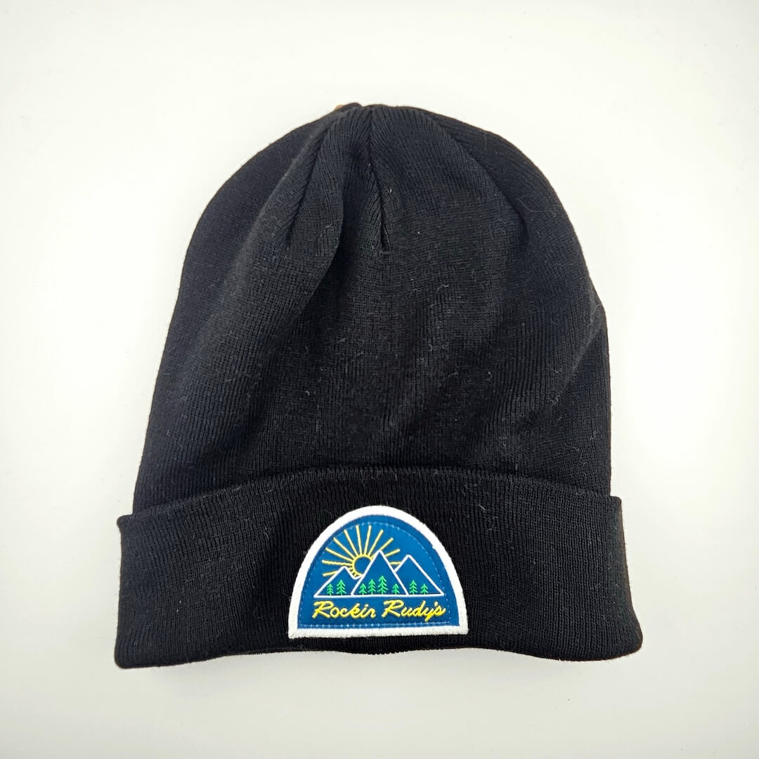Black beanie with a logo patch on cuff for Rockin Rudy's on a white background
