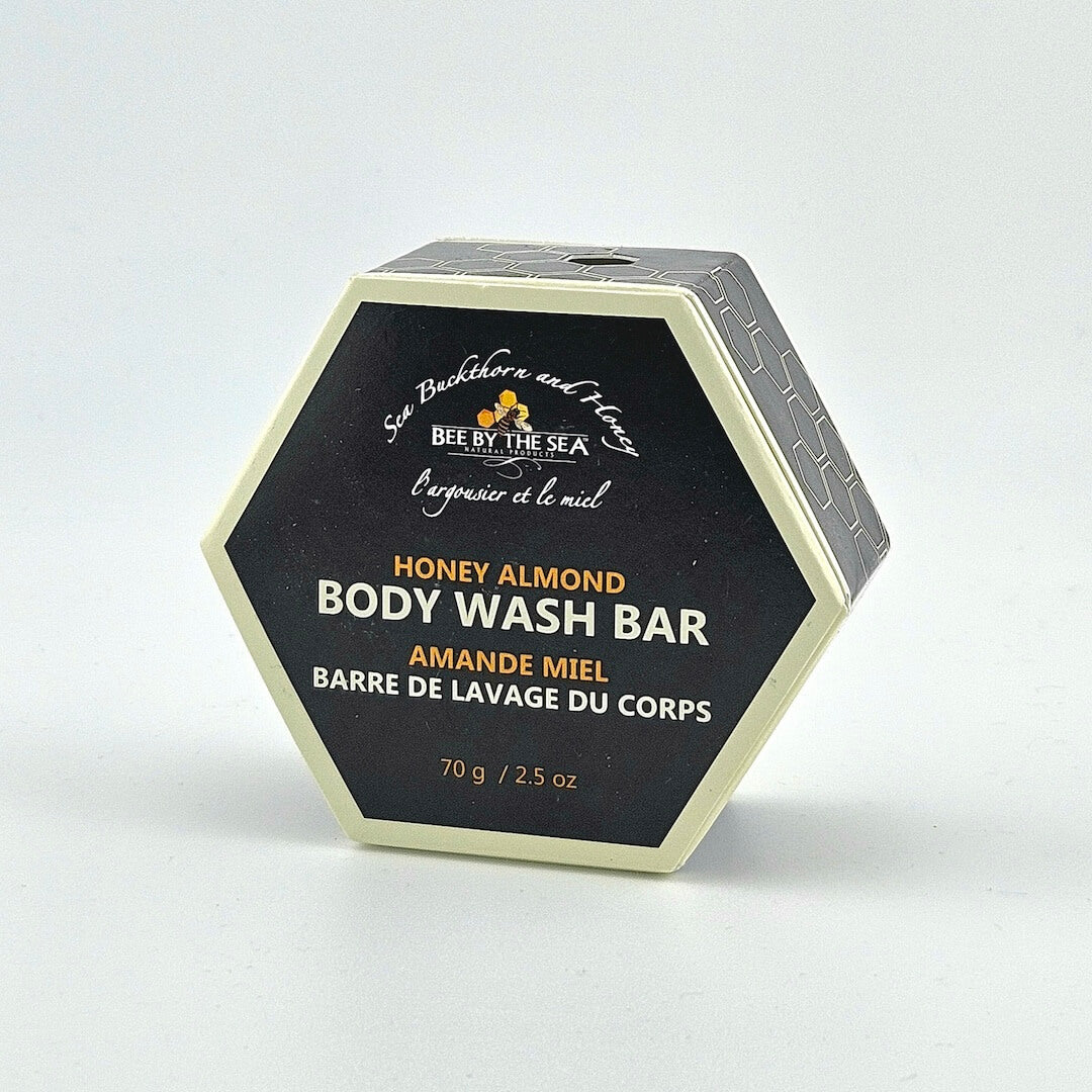 Hexagonal container of Honey Almond body wash bar by Bee by the Sea on a white background