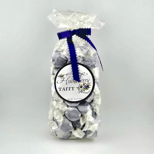 Bag of taffy with a blue ribbon on a white background