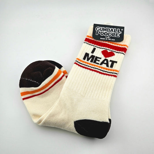 Beige socks with black toes and heels, red and orange stripes with text, "I [heart symbol] meat."