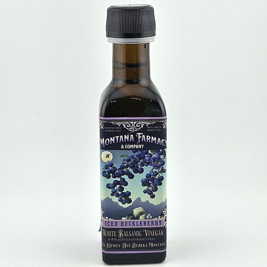 Bottle of Montana Farmacy & Company Huckleberry White Balsamic Vinegar on a white background