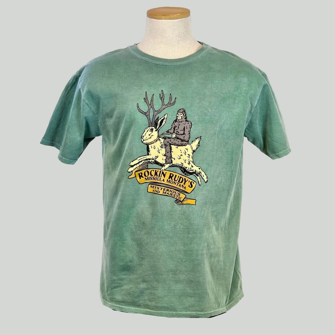 Green t-shirt with a graphic design on a mannequin against a white background